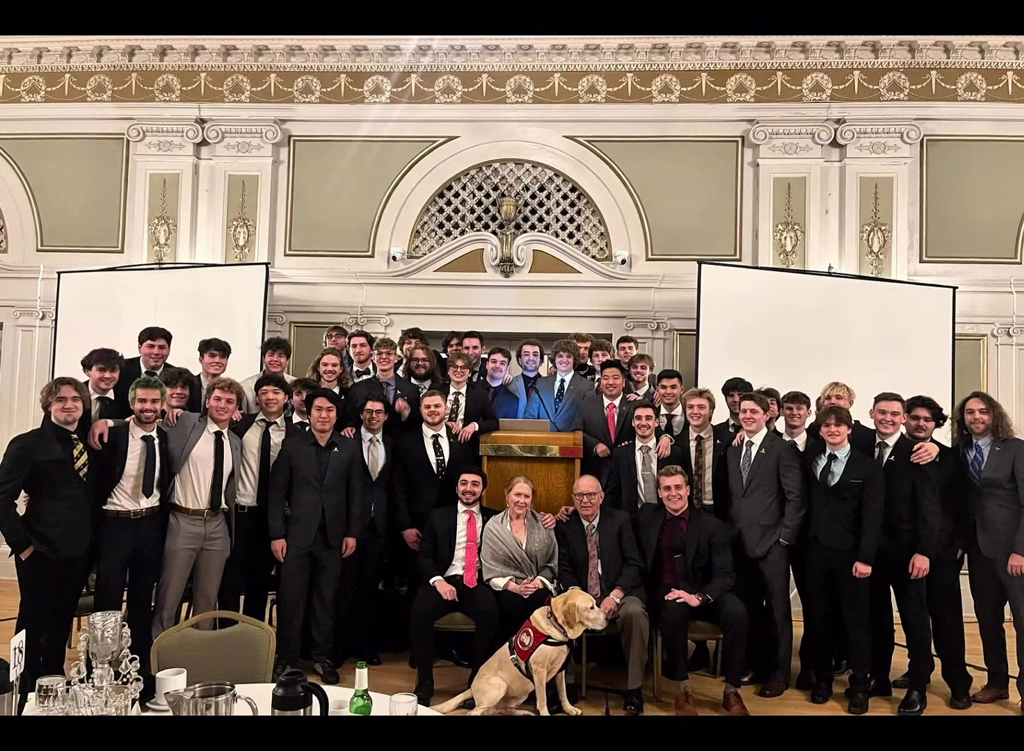 Full chapter group photo with honored guests and a St. Jude service dog