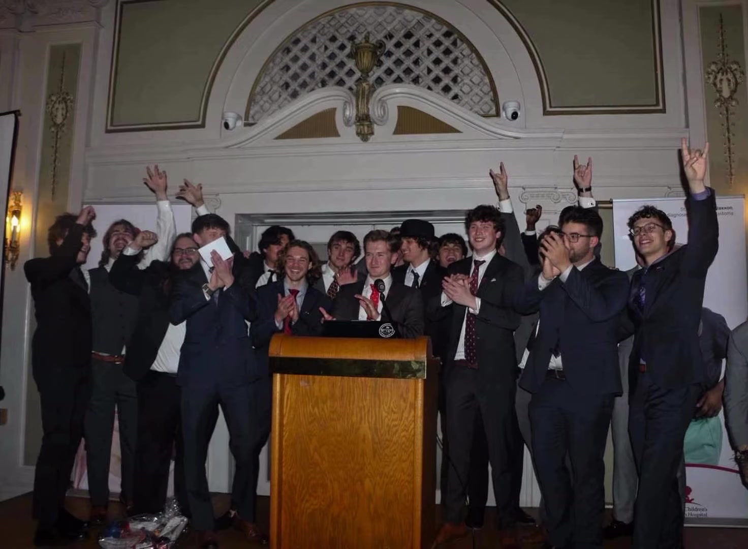 Full chapter embrace at the podium